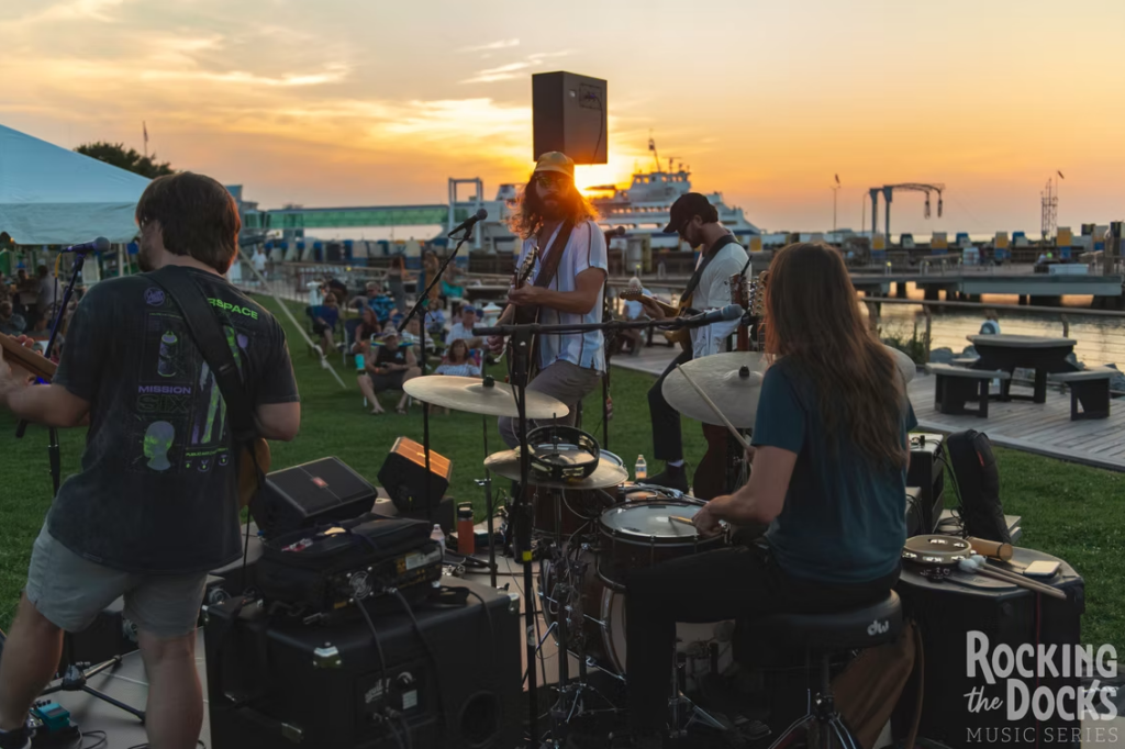 A view from behind the live band while playing at sunset during Grain's "Rocking the Docks Music Series" in 2025