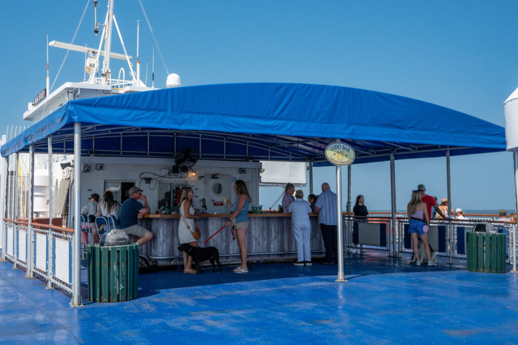 Passengers onboard the Cape May - Lewes Ferry enjoy the sun, wind and views on the outside decks as the Ferry sails across Delaware Bay.