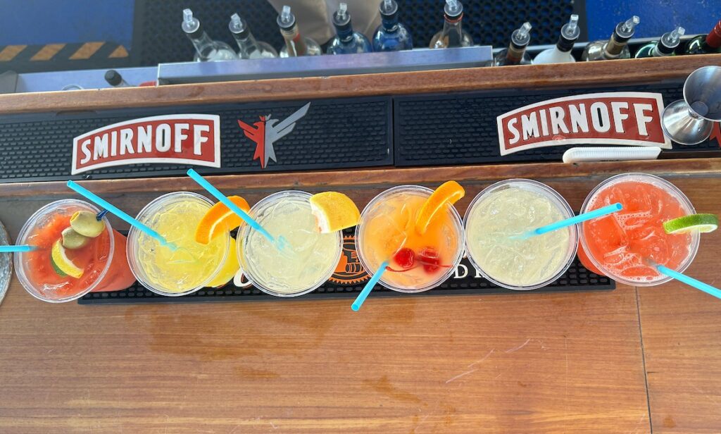 A colorful assortment of 6 cocktails lined up on the Ferry's Lido Bar