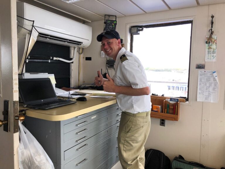 Captain McCann checks the charts before sailing onto Delaware Bay